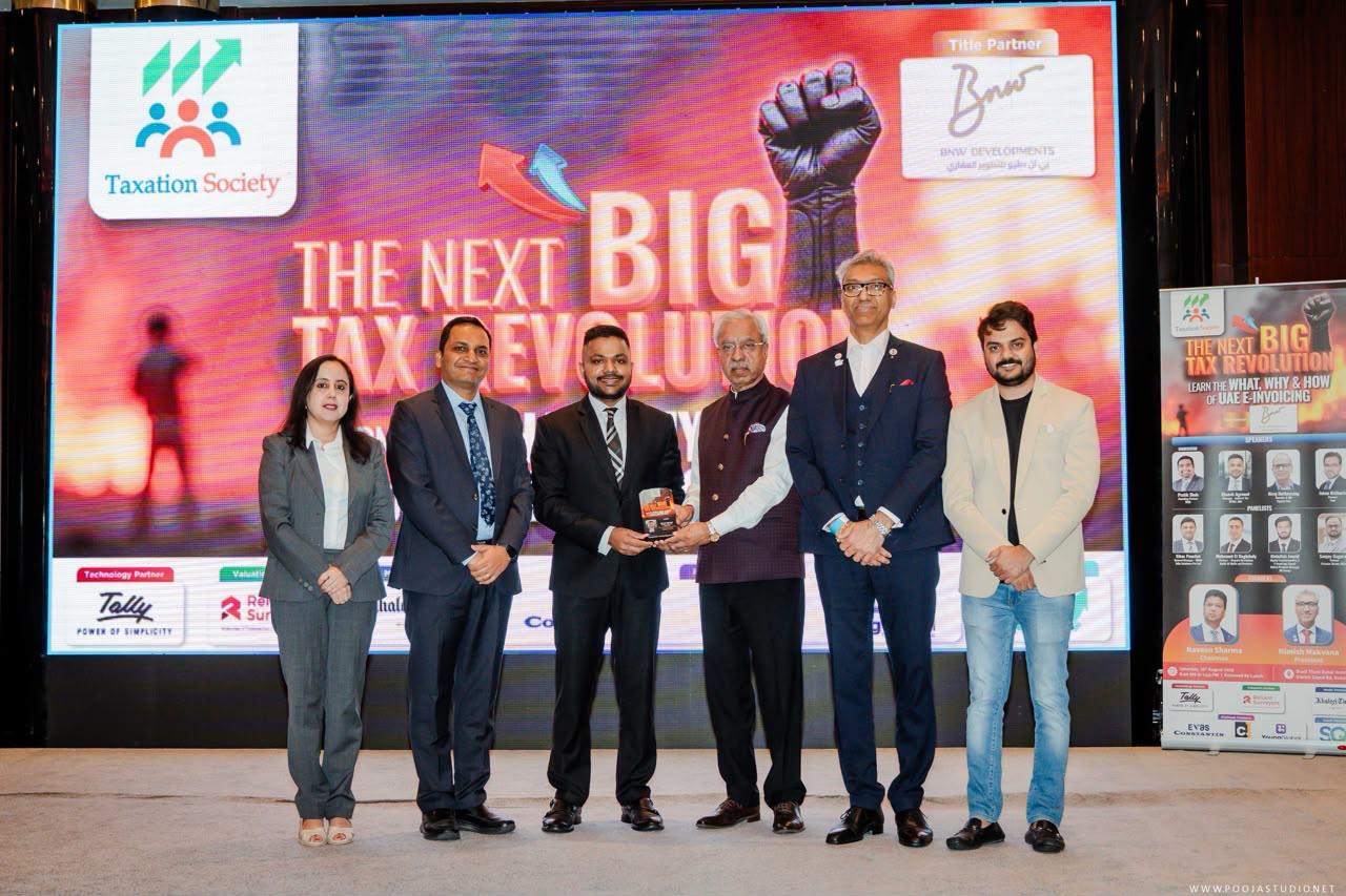 Ekansh Agrawal receiving an award at the Taxation Society's 'The Next Big Tax Revolution' event